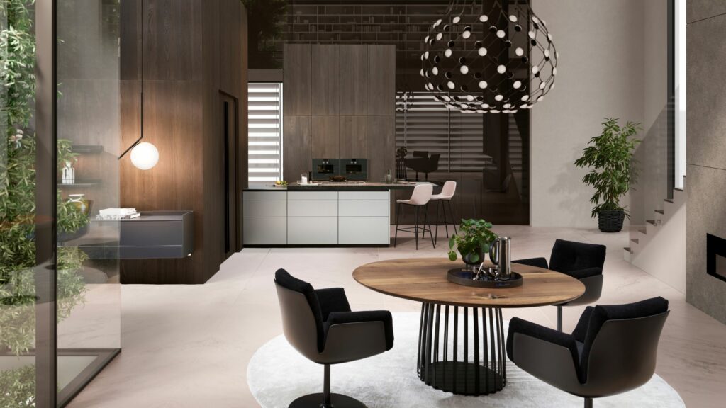Moderne Küche und Essbereich mit rundem Holztisch, vier schwarzen Stühlen, Pendelleuchte, Zimmerpflanzen und minimalistischem Dekor von LEICHT und Möbel Braum.