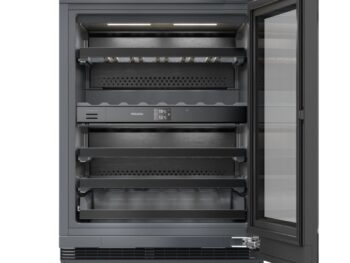 Ein moderner Miele-Weinkühlschrank mit Glastür, vier Einlegeböden und digitaler Temperaturregelung, der in geöffnetem Zustand sein geräumiges, leeres Inneres offenbart. Ideal für Weinliebhaber, die Wert auf Eleganz und präzise Lagerung legen.