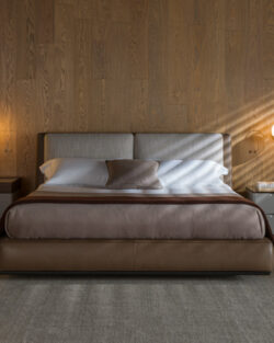 Modernes Schlafzimmer mit einem großen Bett, zwei Nachttischen mit Lampen, einer Stehlampe, einer holzgetäfelten Wand und einem Dekor in neutralen Farben.